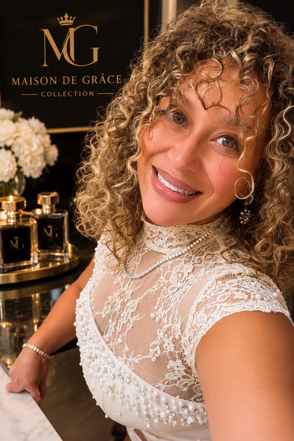 Marlene, founder of Maison de Grâce Collection, beside her fragrances
